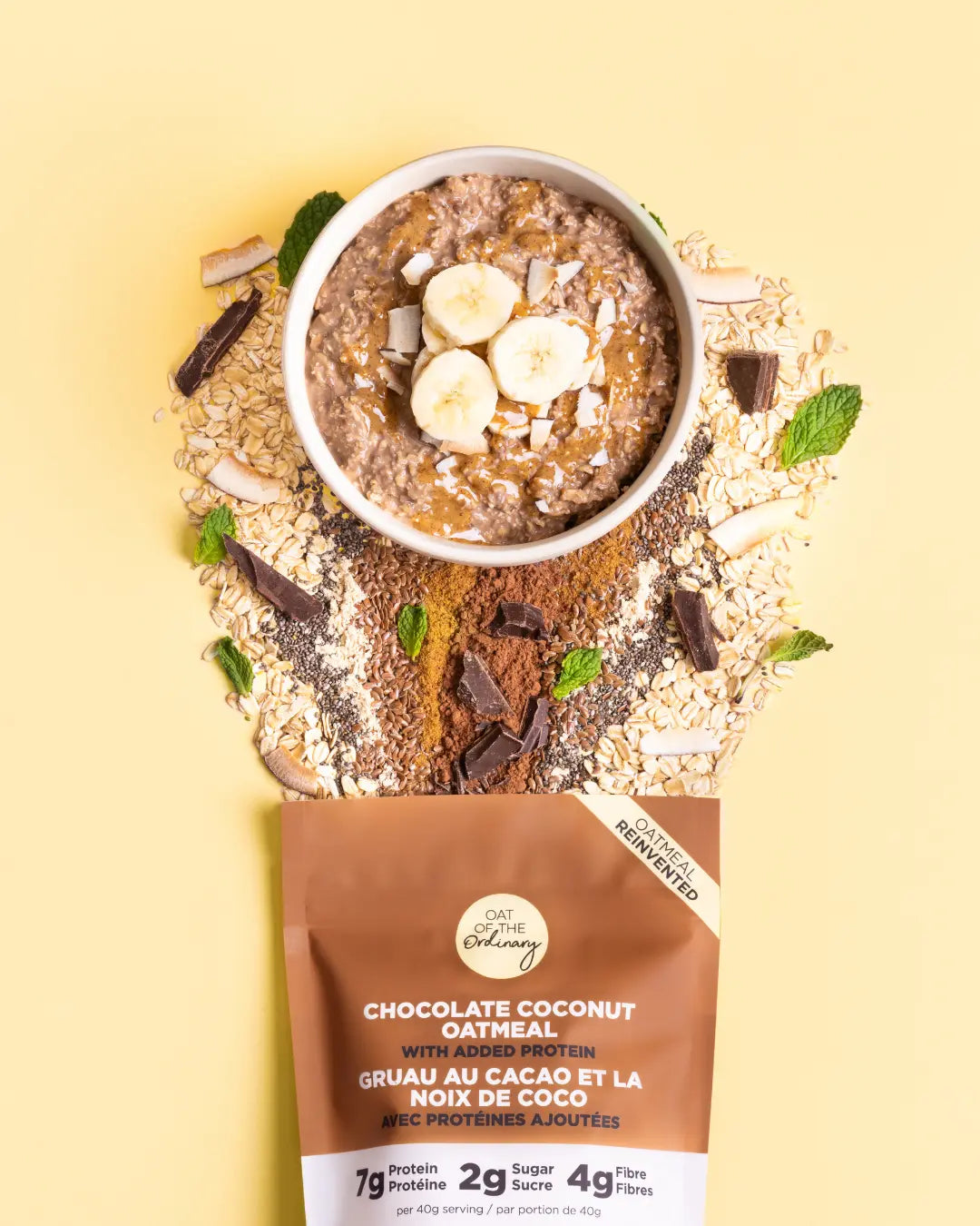 A bowl of chocolate coconut oatmeal with ingredients spilling from a pouch.