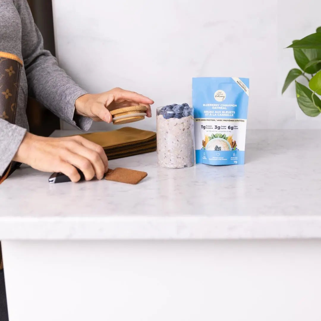 A women taking a jar of overnight blueberry cinnamon oatmeal on the go. 