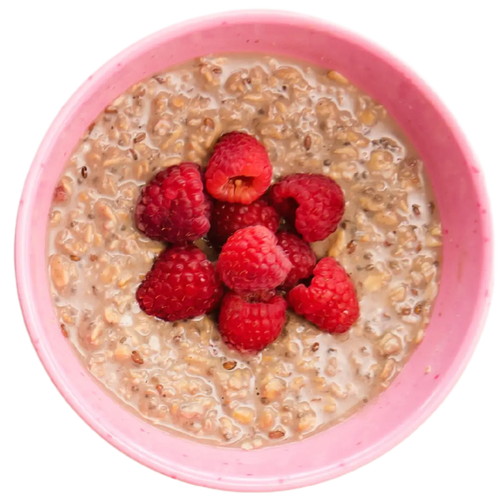 A bowl of raspberry oatmeal with protein, flax, and chia seed and fresh red berry toppings.